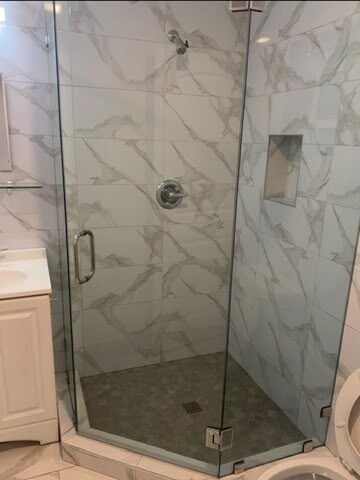 Frameless corner shower glass by NG Windows and Doors